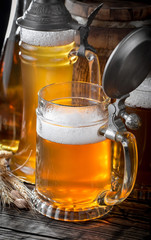 Light beer in a glass on a table in composition with accessories on an old background