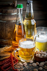 Light beer in a glass, on an old background.