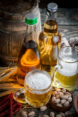 Light beer in a glass on a table in composition with accessories on an old background