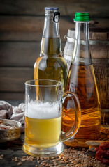 Light beer in a glass on a table in composition with accessories on an old background