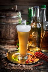 Light beer in a glass, on an old background.