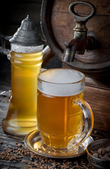 Light beer in a glass on a table in composition with accessories on an old background