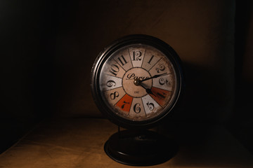 old clock isolated on black background