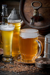 Light frothing beer in a glass, on an old background.