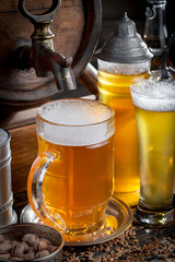 Light beer in a glass, on an old background.