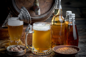 Light frothing beer in a glass, on an old background.