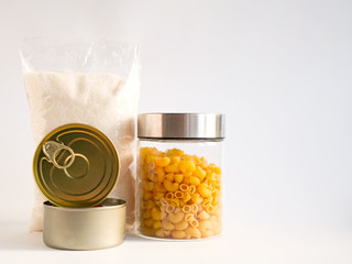 Dry goods, stockpiling, food supplies for staying home concept. Preserves, pasta, sugar on white background.