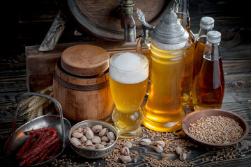 Light beer in a glass, on an old background.