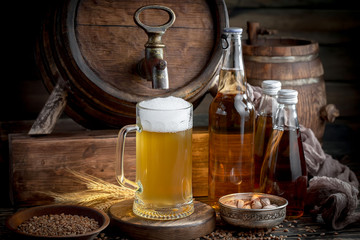 Light frothing beer in a glass, on an old background.