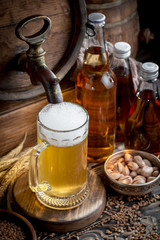 Light beer in a glass on a table in composition with accessories on an old background