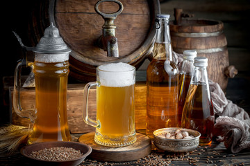 Light beer in a glass, on an old background.