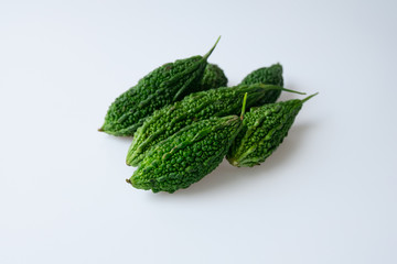 The bitter of gourds named as Momordica charantia are on white background.They are good source of nutrients including vitamins and fiber and also reduce blood sugar that can result in cancer-fighting.