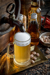 Light beer in a glass on a table in composition with accessories on an old background