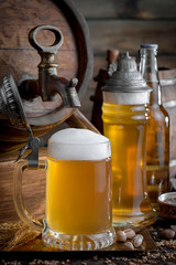 Light beer in a glass on a table in composition with accessories on an old background