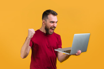 Young bearded man betting online at bookmaker's website