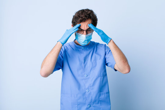 young man looking stressed and frustrated, working under pressure with a headache and troubled with problems. coronavirus concept