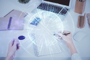 International business hologram over hands taking notes background. Concept of success. Multi...