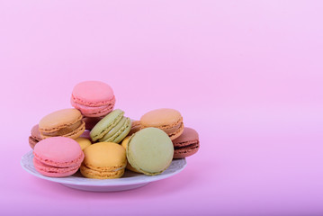 Colorful macaroons cake, sweet macaroon on pink background, food background