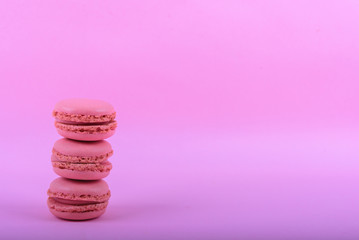 Colorful macaroons cake, sweet macaroon on pink background, food background