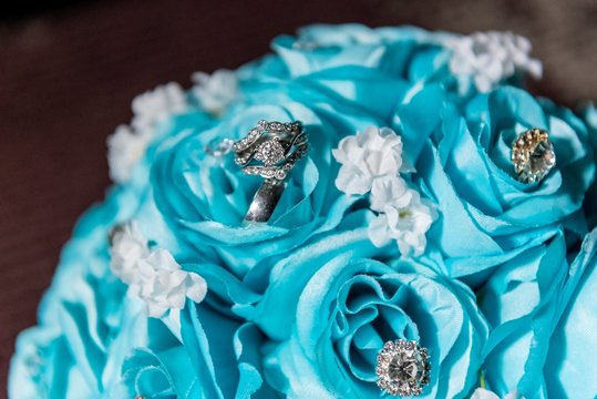 Closeup shot of precious stones on a bouquet with blue roses