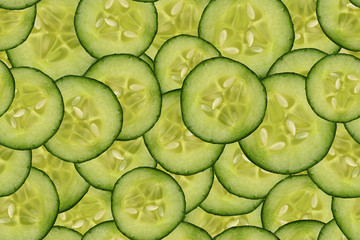 seamless, green pattern of many slices of green fresh vegetables cucumbers, background for the...