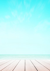 Blur cool sea background with wood floor perspective foreground on horizon tropical sandy beach for wallpaper smartphone Vertical. sky surf summer clouds and light blue wave ocean.