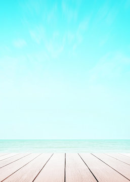 Blur cool sea background with wood floor perspective foreground on horizon tropical sandy beach for wallpaper smartphone Vertical. sky surf summer clouds and light blue wave ocean.