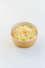 Homemade sauerkraut in a paper bowl. Fermented food, a traditional Russian dish. Plastic free concept.