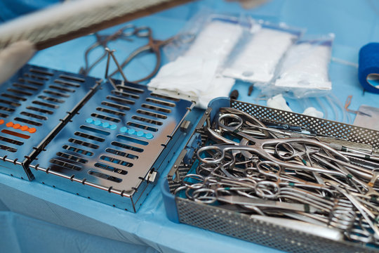 Surgeon prepering a set surgical instruments before surgery.