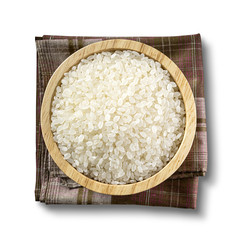 Japanese rice in a wooden bowl, placed on a cloth isolated on white background. with clipping paths.