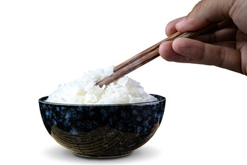 Cooked jasmine rice in ceramic cups and chopsticks holding hot jasmine rice with hand. isolated on white background. with clipping paths.