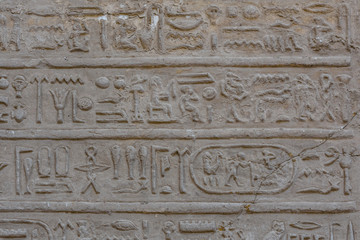 Egyptian ancient hieroglyphs on the stone wall