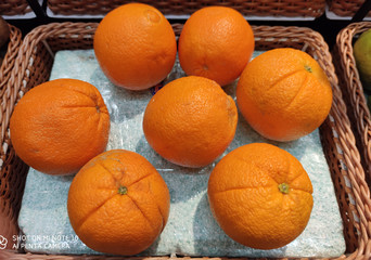 Navel oranges (Citrus sinensis) exposed in wicker basket