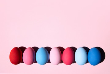 Painted eggs on pastel background.