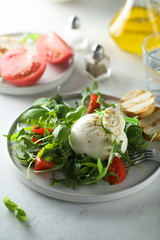 Homemade burrata cheese salad with tomatoes