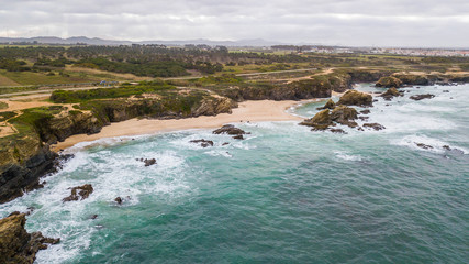 Aerial view of the beach amid cliffs in Portugal. Samoqueira beach, in Porto Covo, Sines