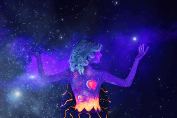 Fototapeta na wymiar girl in ultraviolet light with body art on a black background in ultraviolet with smoke