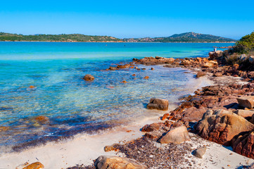 Clear water and rocks in Lu Impostu beach in