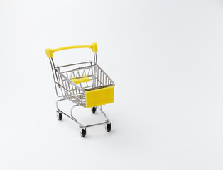 An empty shopping cart with a yellow handle on a white background. Space for text. Front view