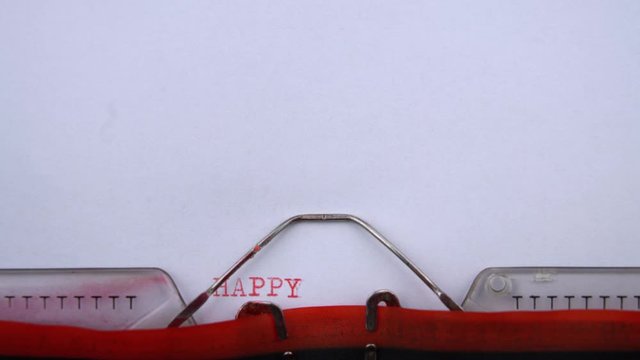 Happy birthday - phrase printed on an old typewriter in red letters, close up. vintage inscription