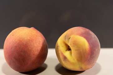 Fototapeta na wymiar Peach fruits (Prunus persica) in natura on a woody background