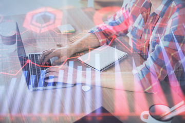 Multi exposure of forex graph with man working on computer on background. Concept of market analysis.