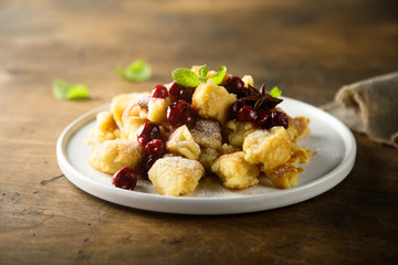 Traditional Austrian pancake dessert with cherry sauce