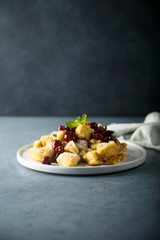 Traditional Austrian pancake dessert with cherry sauce