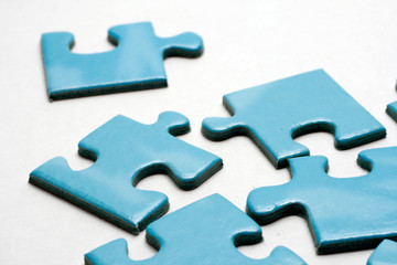 Blue puzzle pieces on white background.