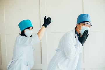 Doctors agitating for vaccination. Funny image of medics doing injection. Health care, disease prevention and medical concept