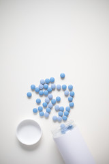 Blue pills on white background