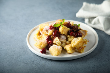 Traditional Austrian pancake dessert with cherry sauce