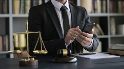 Lawyer Hand USing Smartphone in Court Room