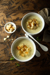 Homemade warming cheese soup with croutons 